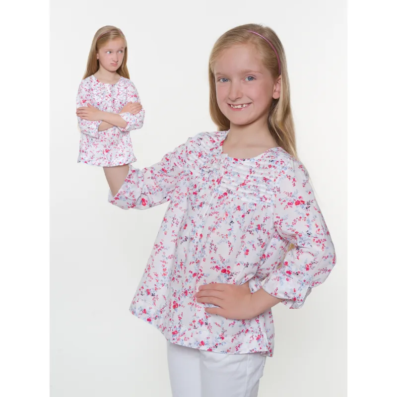 A playful photo montage: a girl holding a miniature version of herself on her outstretched arm